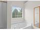 Bathroom features a large soaking tub and natural light at 227 Ferguson Ave, Locust Grove, GA 30248