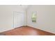 Bedroom with wood-look flooring, closet and neutral walls at 227 Ferguson Ave, Locust Grove, GA 30248