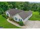 Beautiful home featuring a well-manicured lawn, mature landscaping and a long driveway at 227 Ferguson Ave, Locust Grove, GA 30248