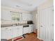 Bright kitchen features white cabinets, laminate countertops and wood-look flooring at 227 Ferguson Ave, Locust Grove, GA 30248