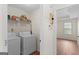 Laundry room with washer and dryer hookups and storage shelving at 227 Ferguson Ave, Locust Grove, GA 30248