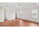 Spacious main bedroom with wood-look flooring, tray ceiling, and ensuite bath at 227 Ferguson Ave, Locust Grove, GA 30248