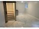 Spacious basement area with marble floors, wooden stairs, and ample potential for customization at 6178 Graceland Cir, Morrow, GA 30260