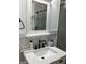 Modern bathroom featuring a white vanity with sleek fixtures and a framed mirror at 6178 Graceland Cir, Morrow, GA 30260