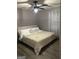 Neutral bedroom featuring a comfortable bed, soft bedding, ceiling fan and ample natural light at 6178 Graceland Cir, Morrow, GA 30260