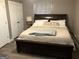 Comfortable bedroom featuring a large dark wood bed with soft linens and a neutral color scheme at 6178 Graceland Cir, Morrow, GA 30260