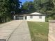 Charming single-story home featuring a neatly manicured lawn and a long driveway at 6178 Graceland Cir, Morrow, GA 30260