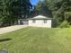 Charming single-story home with manicured lawn and mature trees, perfect for suburban living at 6178 Graceland Cir, Morrow, GA 30260