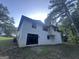 Exterior of white painted brick home featuring a dark roof and black framed windows at 6178 Graceland Cir, Morrow, GA 30260