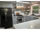 Modern kitchen featuring stainless steel appliances, gray cabinets, and quartz countertops at 6178 Graceland Cir, Morrow, GA 30260