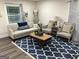 Comfortable living room with stylish furnishings, a patterned rug, and plenty of natural light at 6178 Graceland Cir, Morrow, GA 30260