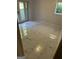 Room features marble-look tile flooring, white walls, and a glass door leading to the outdoors at 6178 Graceland Cir, Morrow, GA 30260