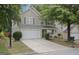 Charming two-story home features a two-car garage and a well-manicured front lawn at 3347 Sable Glen, Atlanta, GA 30349