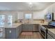 Bright kitchen features stainless steel appliances, gray cabinets, and ample counter space at 3347 Sable Glen, Atlanta, GA 30349