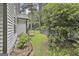 View of side yard showing mature trees and gate at 128 Rubicon Rd, Peachtree City, GA 30269