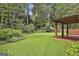 Beautiful backyard with mature trees and landscaped garden at 128 Rubicon Rd, Peachtree City, GA 30269