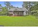 Manicured backyard with covered patio at 128 Rubicon Rd, Peachtree City, GA 30269