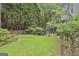 Manicured backyard with fenced yard and mature landscaping at 128 Rubicon Rd, Peachtree City, GA 30269