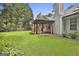 View of the side and back yard featuring covered patio, siding and chimney at 128 Rubicon Rd, Peachtree City, GA 30269