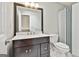Clean bathroom features a modern vanity with marble countertop and a shower with striped curtains at 128 Rubicon Rd, Peachtree City, GA 30269