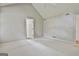 Bright bedroom features neutral carpet, vaulted ceiling, and an open doorway at 128 Rubicon Rd, Peachtree City, GA 30269