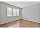 This light-filled bedroom has hardwood floors and a large window at 128 Rubicon Rd, Peachtree City, GA 30269