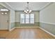 Elegant dining room with wood floors, a chandelier, and natural light at 128 Rubicon Rd, Peachtree City, GA 30269