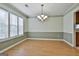 Spacious dining room with wood floors, large windows, and chandelier at 128 Rubicon Rd, Peachtree City, GA 30269