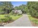 Long driveway leading to a well-maintained home surrounded by lush greenery at 128 Rubicon Rd, Peachtree City, GA 30269