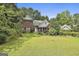 Traditional brick home with a manicured lawn and mature trees at 128 Rubicon Rd, Peachtree City, GA 30269