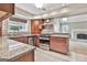 Well-equipped kitchen with granite counters and stainless steel appliances, open to the living room at 128 Rubicon Rd, Peachtree City, GA 30269