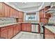 Modern kitchen with granite countertops, wood cabinets, and stainless appliances at 128 Rubicon Rd, Peachtree City, GA 30269