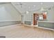 Open concept living room with view to kitchen area, light walls and wood flooring at 128 Rubicon Rd, Peachtree City, GA 30269