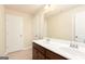 Bathroom with a double vanity, tile floor, large mirror, and white doors at 4830 Northridge Dr, Cumming, GA 30041