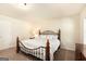 Cozy bedroom with a decorative bed frame and bedside table lamp at 4830 Northridge Dr, Cumming, GA 30041