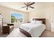 Bright bedroom features a ceiling fan, carpet, and a window with lovely neighborhood views at 4830 Northridge Dr, Cumming, GA 30041