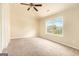 Bedroom with neutral carpet, a ceiling fan, and a large window at 4830 Northridge Dr, Cumming, GA 30041
