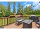 Outdoor deck featuring seating, a fire pit, and a built-in grill at 4830 Northridge Dr, Cumming, GA 30041