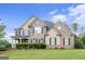 Beautiful two-story home with a well manicured lawn and a combination of stone and brick facade at 4830 Northridge Dr, Cumming, GA 30041