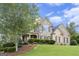 Spacious two-story home with stone and brick facade, beautiful landscaping and a well manicured lawn at 4830 Northridge Dr, Cumming, GA 30041