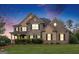 Beautiful two-story home with a well manicured lawn and a combination of stone and brick facade at 4830 Northridge Dr, Cumming, GA 30041