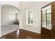Elegant foyer with hardwood floors, arched doorway, and natural light at 4830 Northridge Dr, Cumming, GA 30041