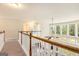 Second-floor hallway overlooking the living area below with floor to ceiling windows at 4830 Northridge Dr, Cumming, GA 30041