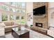Bright living room with a stone fireplace, built-in shelving, and large windows with lots of natural light at 4830 Northridge Dr, Cumming, GA 30041