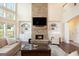 Bright living room with a stone fireplace, built-in shelving, and large windows allowing lots of natural light at 4830 Northridge Dr, Cumming, GA 30041
