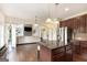 Open-concept living space featuring kitchen island, stone fireplace, and seamless flow for entertaining at 4830 Northridge Dr, Cumming, GA 30041