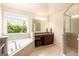 Inviting bathroom featuring a soaking tub, a frameless shower, and natural lighting at 4830 Northridge Dr, Cumming, GA 30041