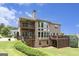 Expansive home with multiple levels of decking overlooking a lush, green backyard oasis at 4830 Northridge Dr, Cumming, GA 30041