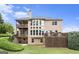 Charming home exterior boasts multiple decks and large windows overlooking a beautiful backyard at 4830 Northridge Dr, Cumming, GA 30041