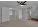 Spacious bedroom with a ceiling fan and view of the stairs to the next floor of the home at 115 Rockhurst Chase, Tyrone, GA 30290